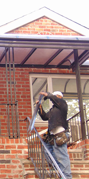 A man holding a metal bar in front of a building.