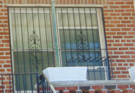 A brick building with iron bars on the windows.